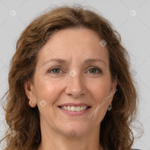 Joyful white adult female with long  brown hair and grey eyes