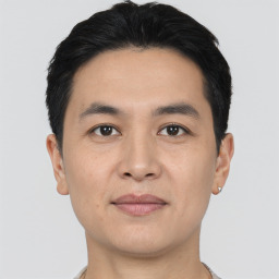 Joyful asian young-adult male with short  black hair and brown eyes