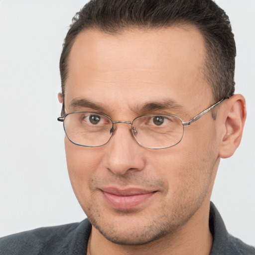 Joyful white adult male with short  brown hair and brown eyes