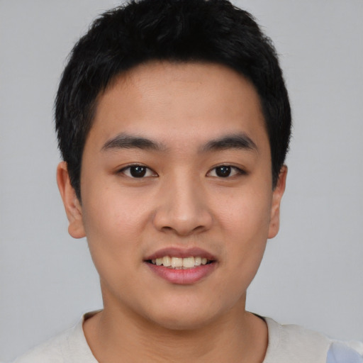 Joyful asian young-adult male with short  black hair and brown eyes