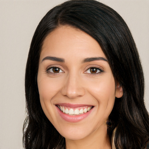 Joyful white young-adult female with long  black hair and brown eyes