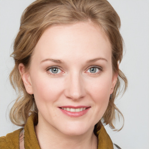 Joyful white young-adult female with medium  brown hair and blue eyes