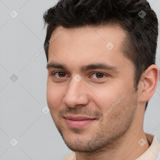 Joyful white young-adult male with short  brown hair and brown eyes