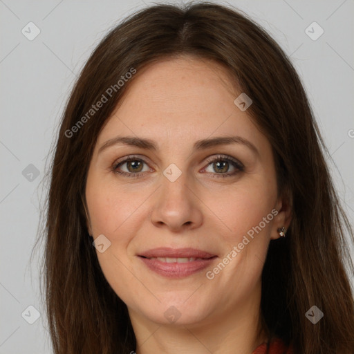 Joyful white adult female with long  brown hair and brown eyes