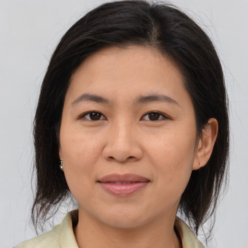 Joyful asian young-adult female with medium  brown hair and brown eyes
