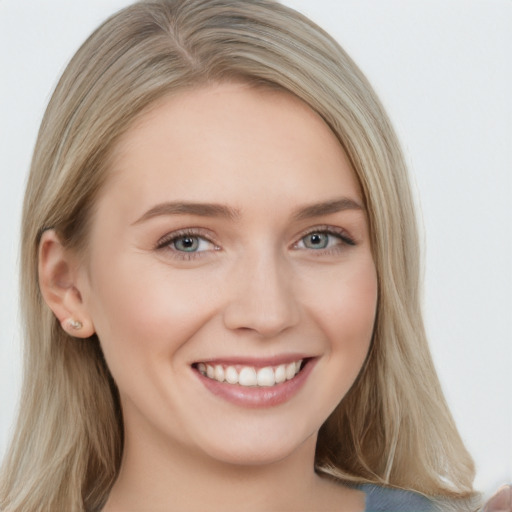 Joyful white young-adult female with long  brown hair and blue eyes