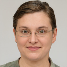 Joyful white adult female with short  brown hair and grey eyes