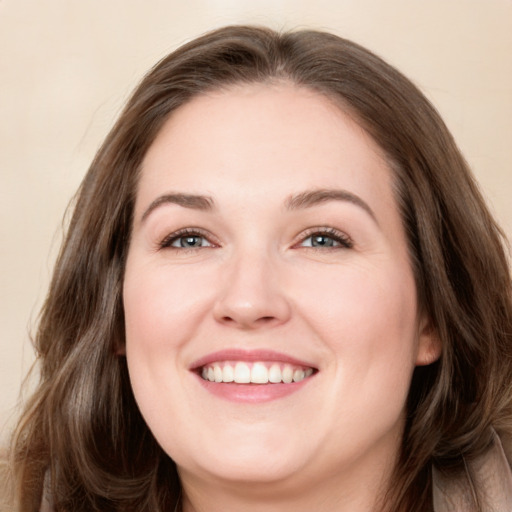 Joyful white young-adult female with long  brown hair and green eyes