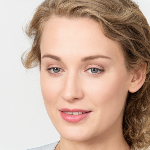 Joyful white young-adult female with medium  brown hair and blue eyes