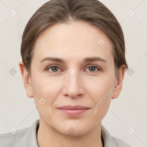 Joyful white young-adult female with short  brown hair and grey eyes