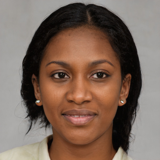 Joyful black young-adult female with medium  black hair and brown eyes