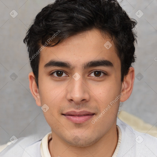 Joyful latino young-adult male with short  brown hair and brown eyes