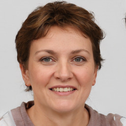 Joyful white adult female with short  brown hair and brown eyes