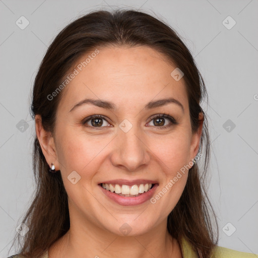 Joyful white young-adult female with long  brown hair and brown eyes