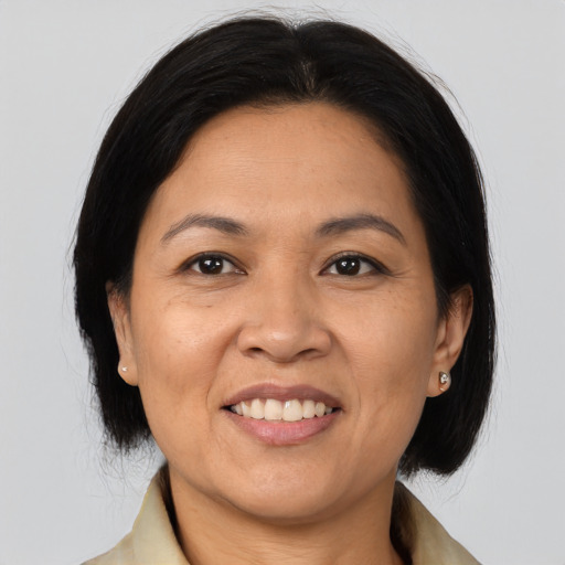 Joyful asian adult female with medium  brown hair and brown eyes