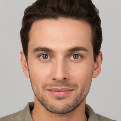 Joyful white young-adult male with short  brown hair and brown eyes