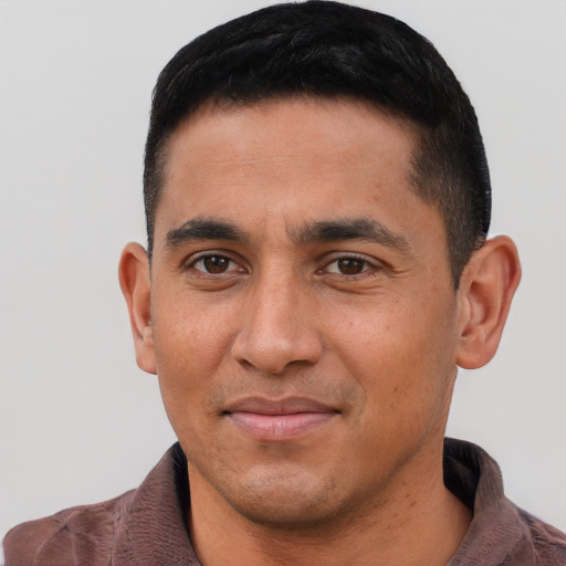 Joyful latino young-adult male with short  black hair and brown eyes