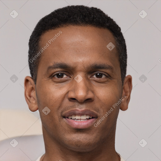 Joyful black young-adult male with short  brown hair and brown eyes