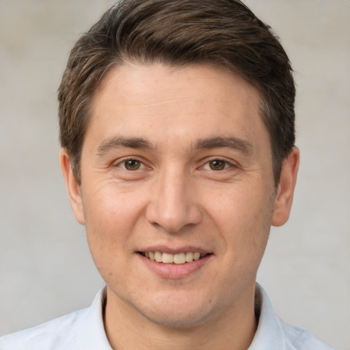 Joyful white adult male with short  brown hair and brown eyes