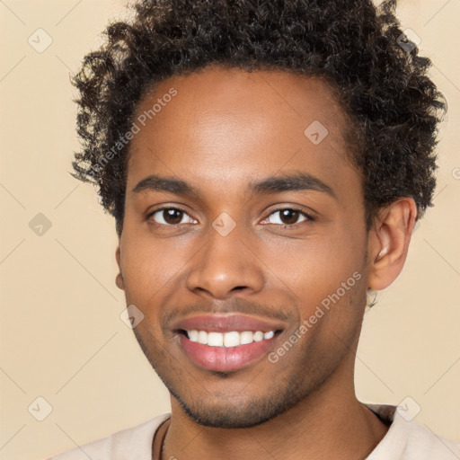 Joyful black young-adult male with short  brown hair and brown eyes