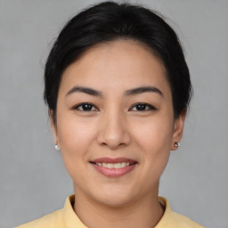 Joyful asian young-adult female with short  black hair and brown eyes