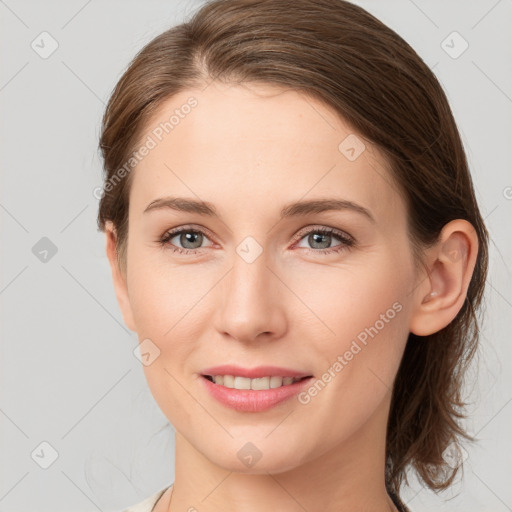 Joyful white young-adult female with medium  brown hair and grey eyes