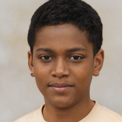 Joyful black child male with short  brown hair and brown eyes