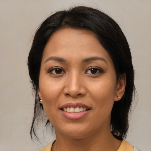 Joyful asian young-adult female with medium  brown hair and brown eyes