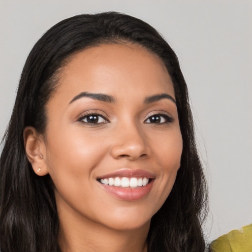 Joyful latino young-adult female with long  brown hair and brown eyes