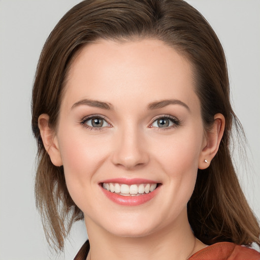 Joyful white young-adult female with medium  brown hair and grey eyes