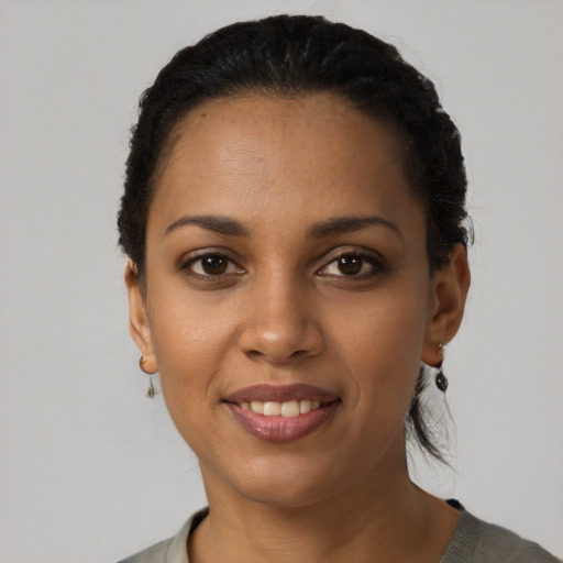 Joyful latino young-adult female with short  black hair and brown eyes