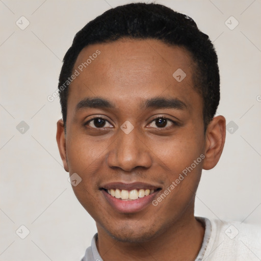 Joyful black young-adult male with short  black hair and brown eyes