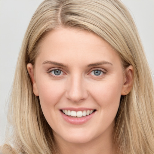 Joyful white young-adult female with long  brown hair and grey eyes