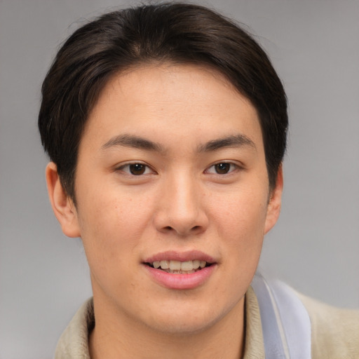 Joyful asian young-adult female with short  brown hair and brown eyes