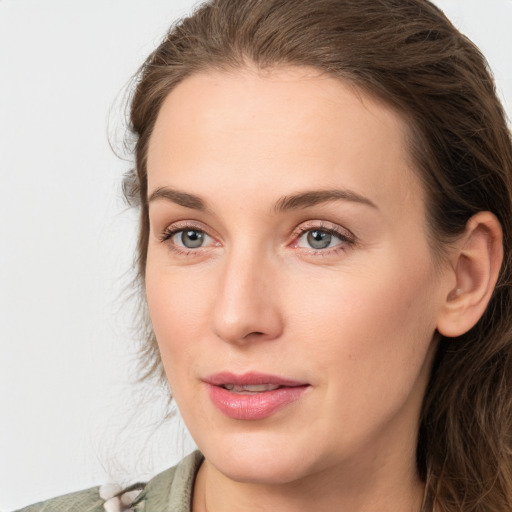 Joyful white young-adult female with medium  brown hair and blue eyes