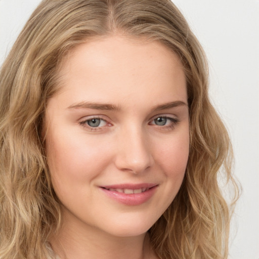 Joyful white young-adult female with long  brown hair and blue eyes