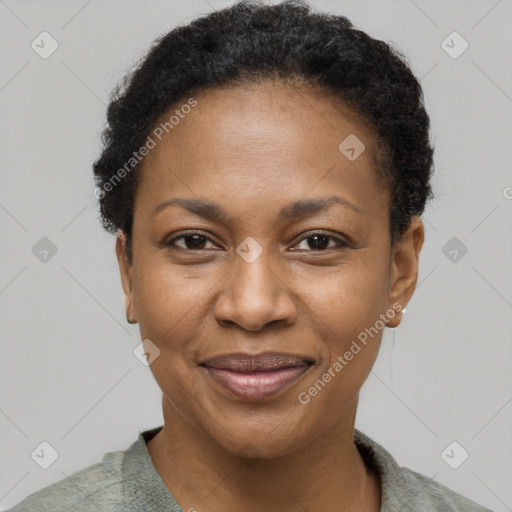 Joyful black adult female with short  black hair and brown eyes