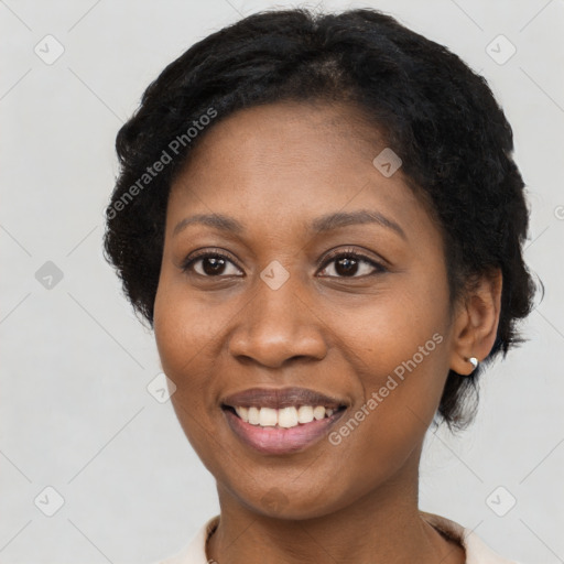 Joyful black young-adult female with short  black hair and brown eyes