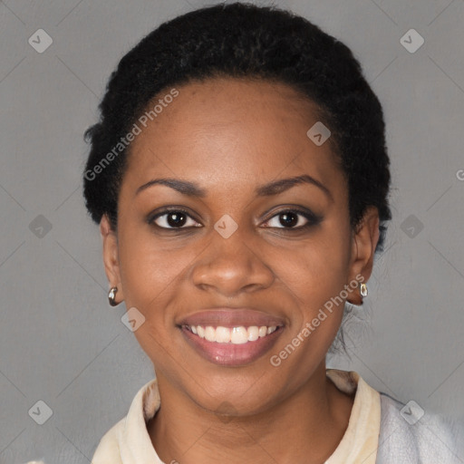 Joyful black young-adult female with short  black hair and brown eyes