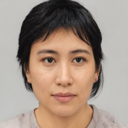 Neutral asian young-adult female with medium  brown hair and brown eyes