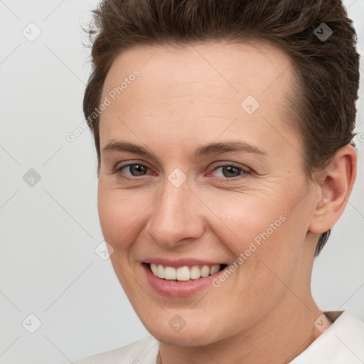 Joyful white young-adult female with short  brown hair and brown eyes