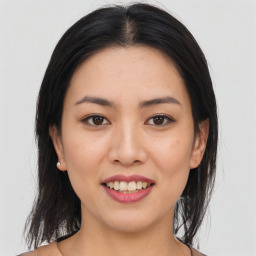 Joyful asian young-adult female with long  brown hair and brown eyes