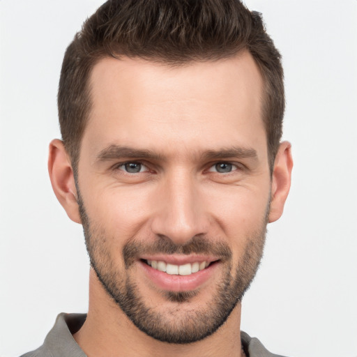 Joyful white young-adult male with short  brown hair and brown eyes