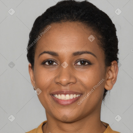 Joyful black young-adult female with short  brown hair and brown eyes