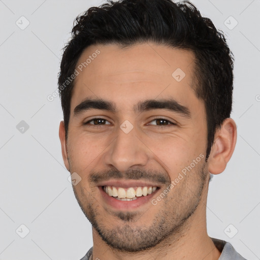 Joyful white young-adult male with short  black hair and brown eyes