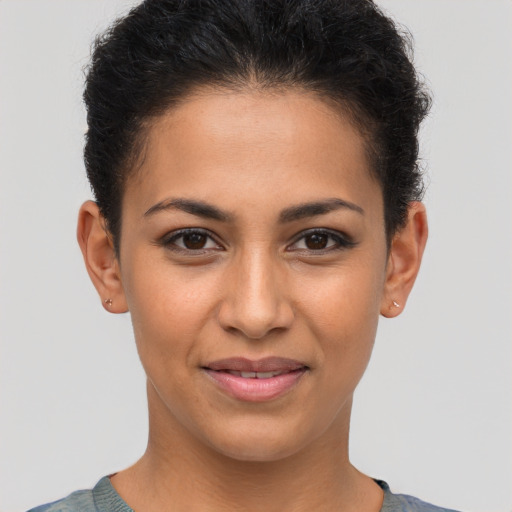 Joyful latino young-adult female with short  brown hair and brown eyes