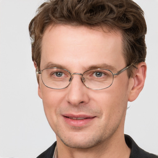 Joyful white adult male with short  brown hair and grey eyes