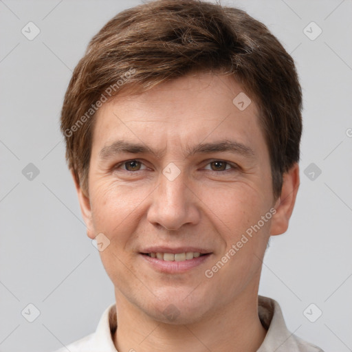 Joyful white adult male with short  brown hair and grey eyes