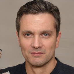 Joyful white adult male with short  brown hair and brown eyes