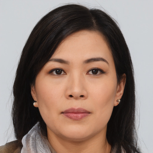 Joyful asian young-adult female with medium  brown hair and brown eyes